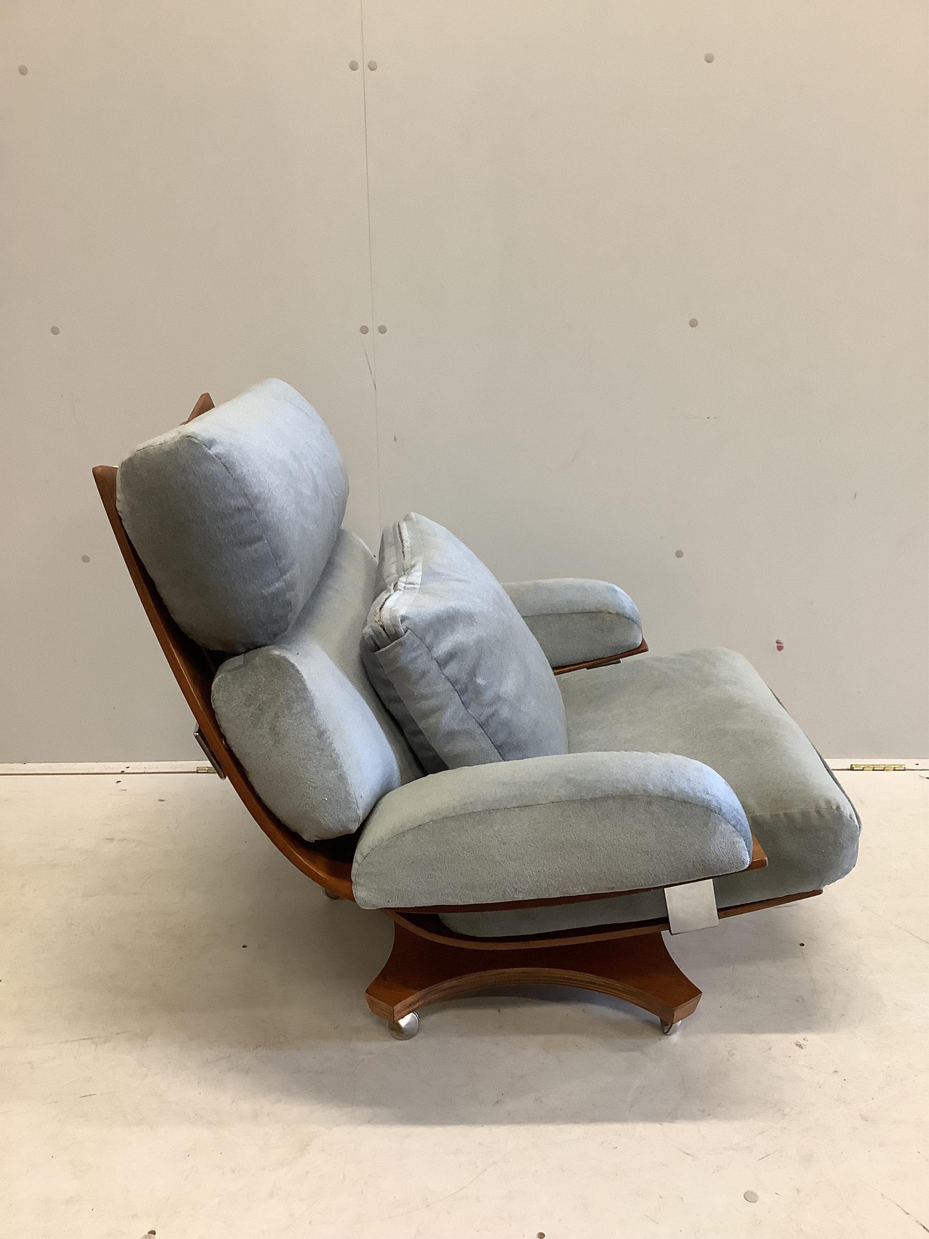 A mid century G Plan Housemaster teak swivel armchair with pale blue loose cushions, width 88cm, depth 66cm, height 81cm. Condition - fair to good